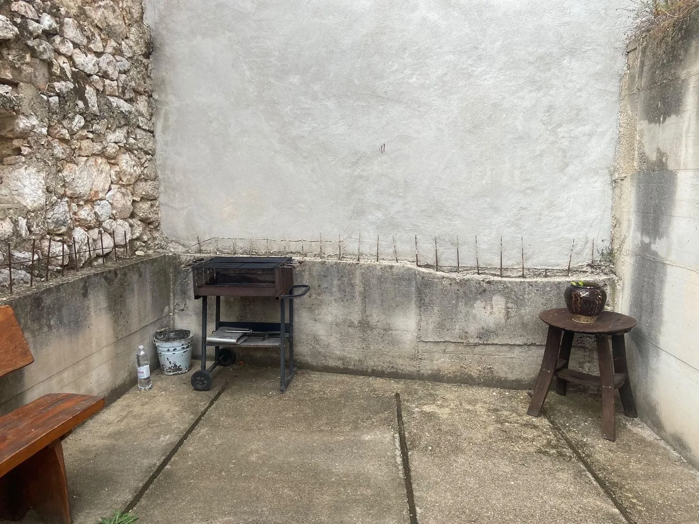 The grill against the plastered wall inside the ruin