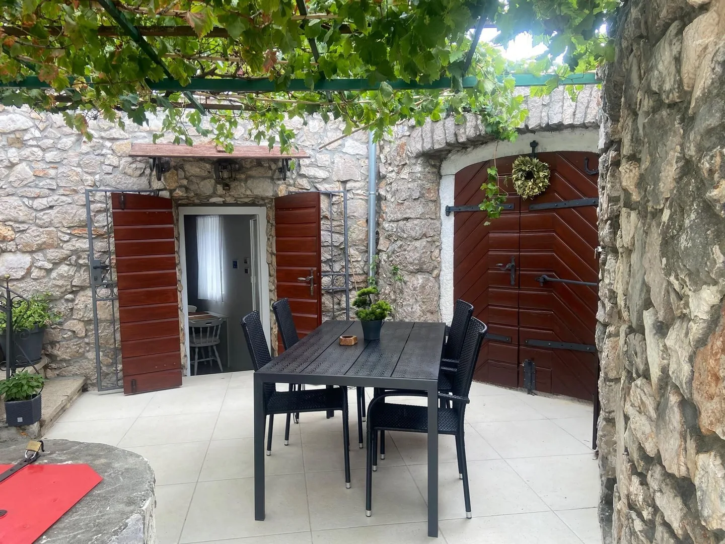 The terrace table beside the wooden door of the konoba