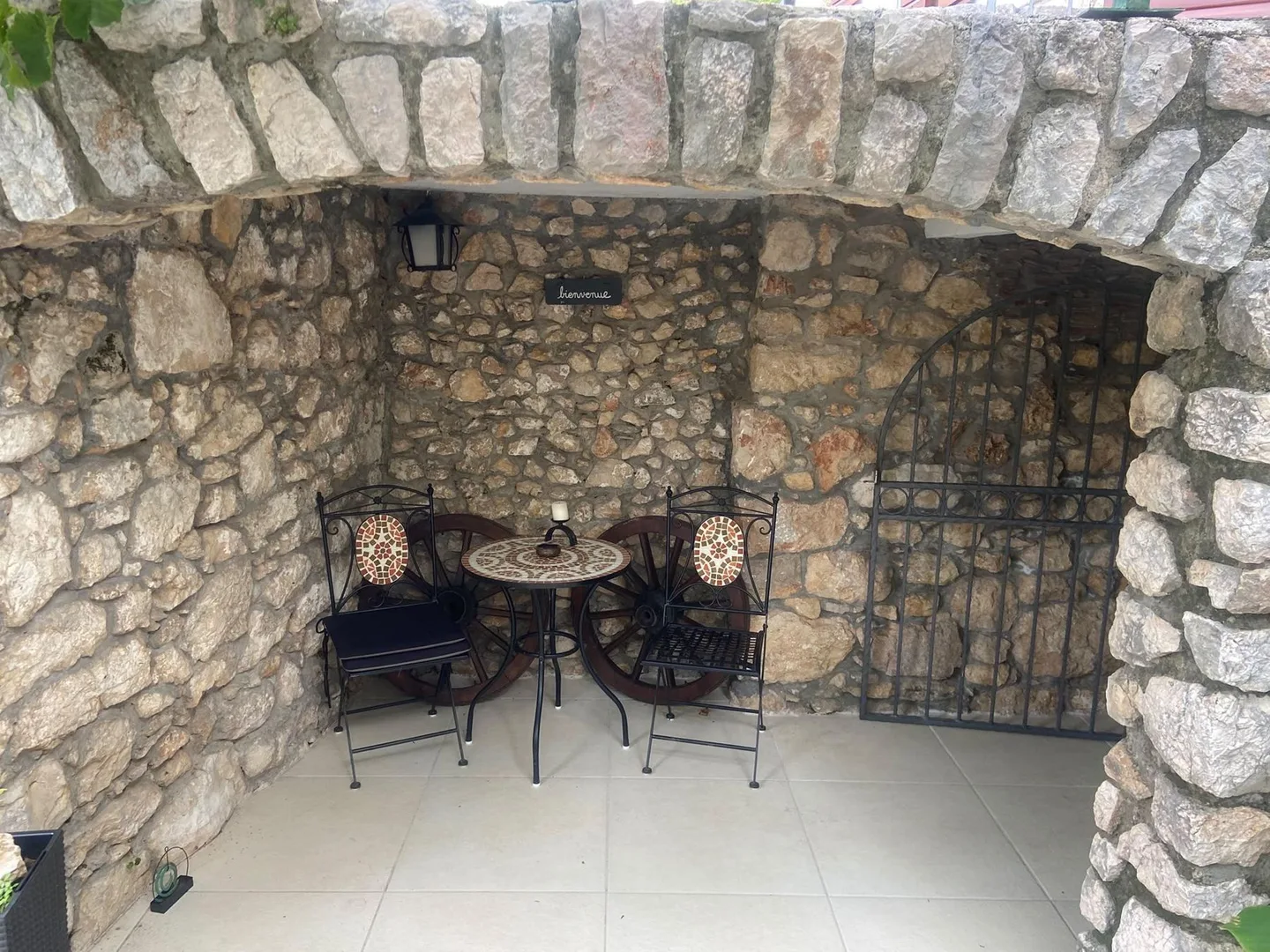 The stone alcove with a bistro table and two chairs