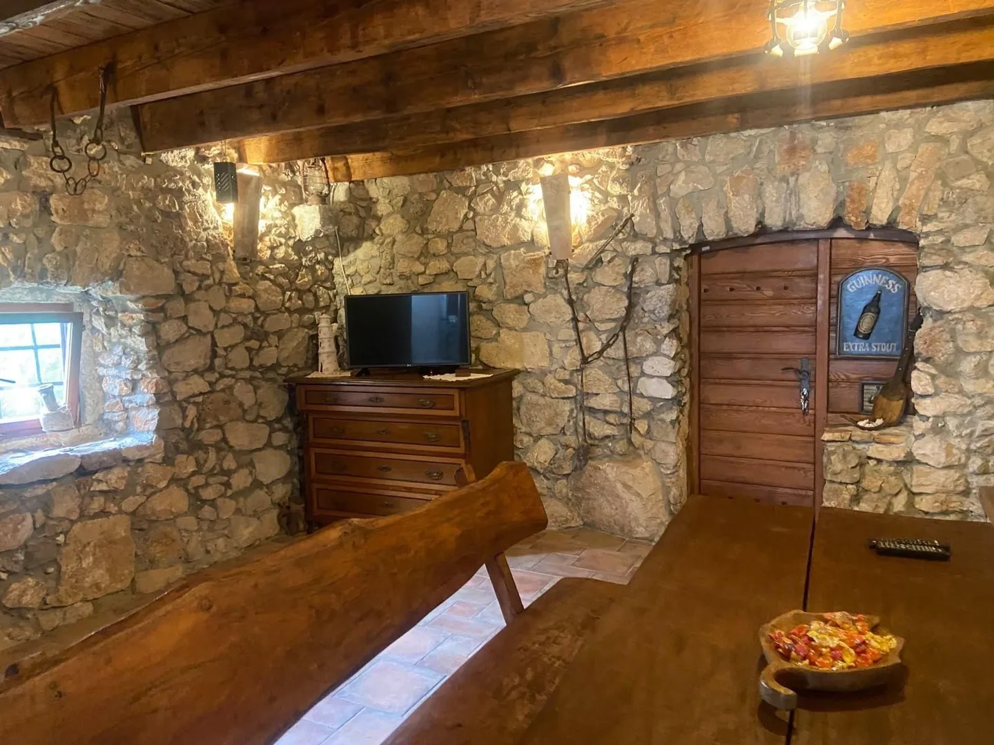 The wooden door and the chest of drawers at the end of the konoba
