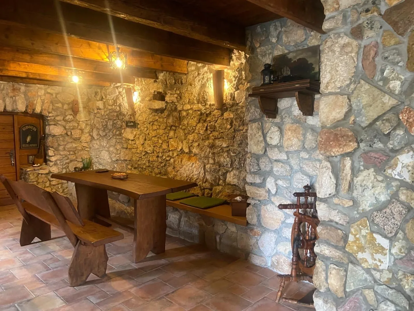 The konoba table in warm light, beside a stone pillar