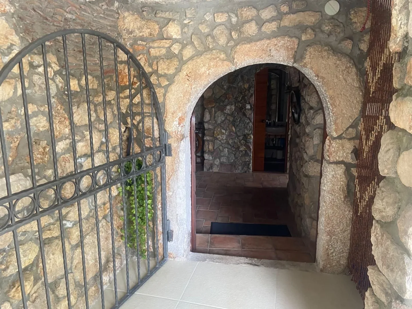 The konoba entrance: a stone arch with a wrought-iron gate