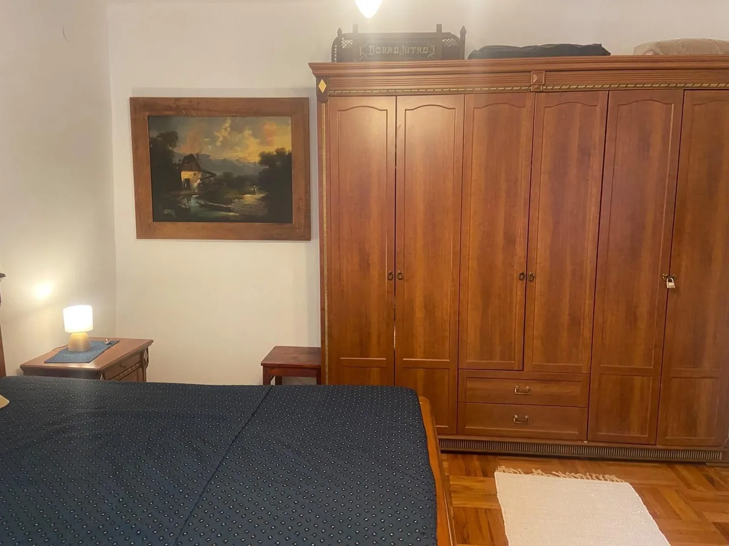 The carved wardrobe and a landscape painting