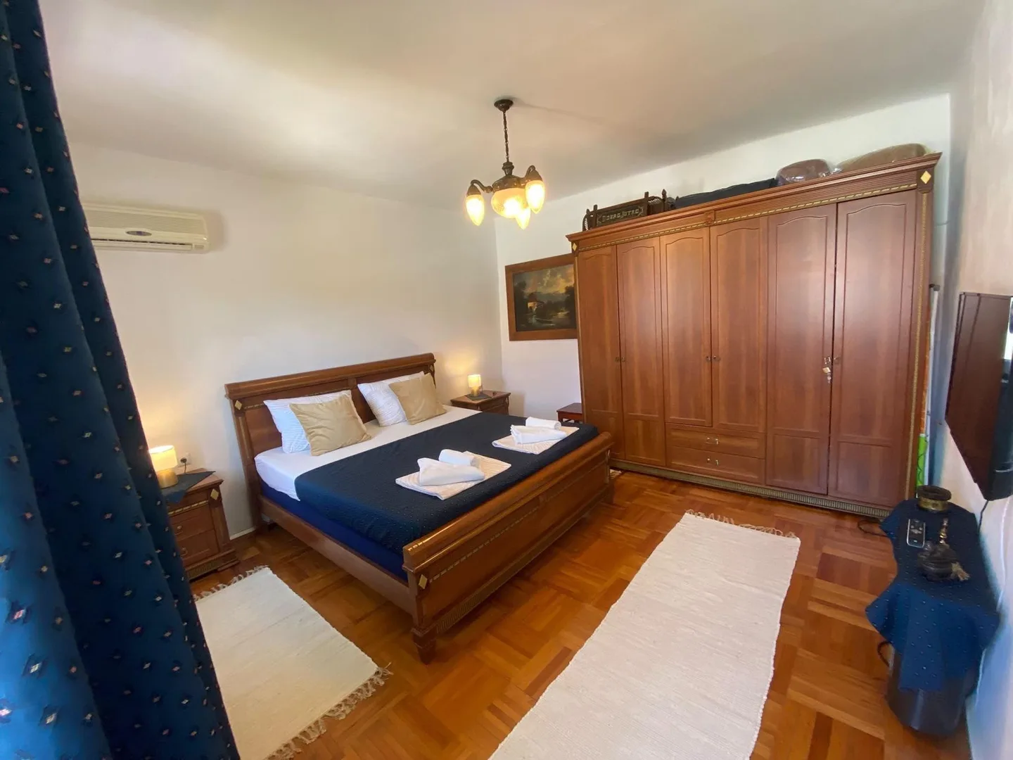 The whole room: bed, wardrobe and parquet floor