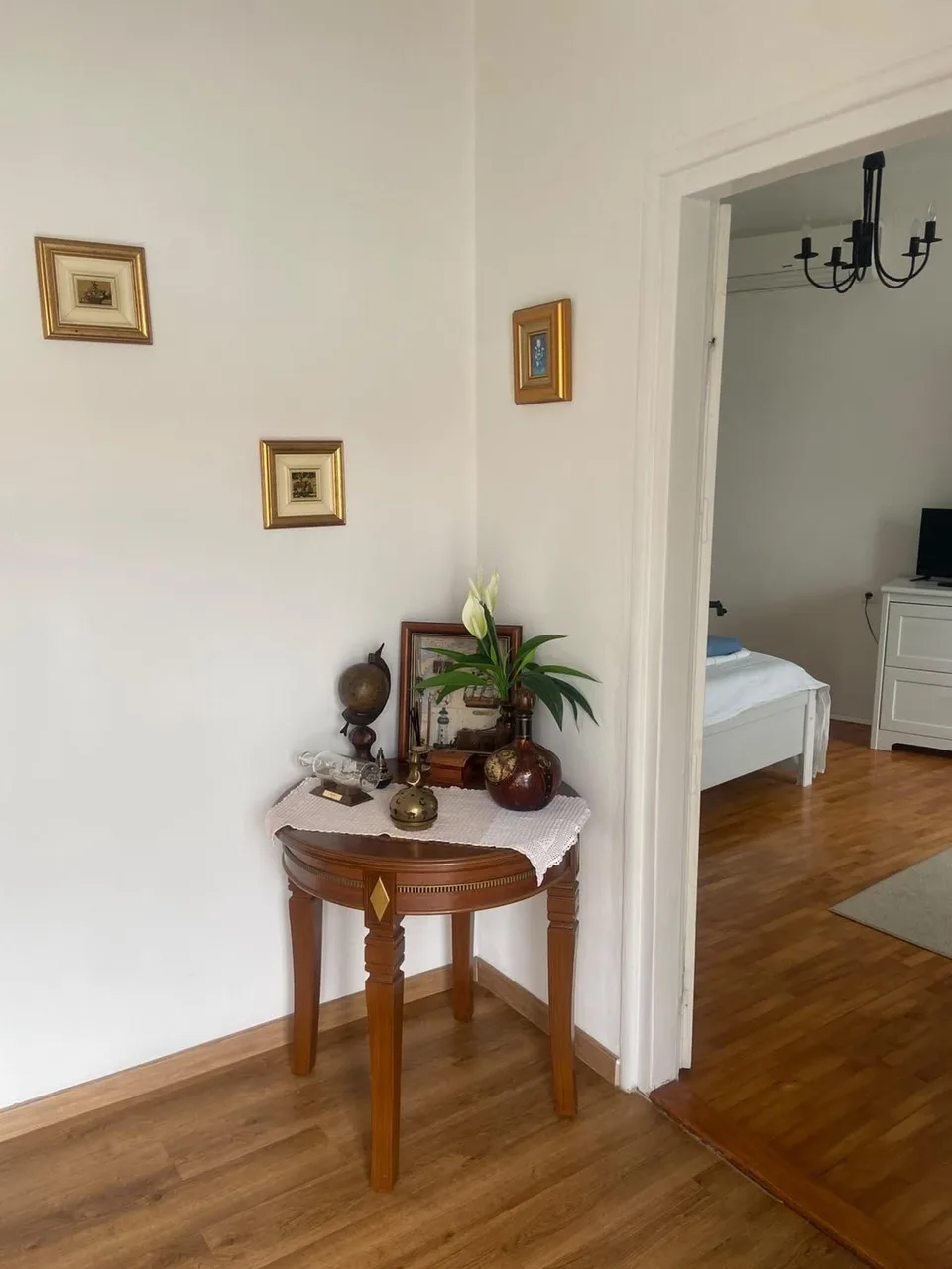 The hallway, a door open to the white bedroom