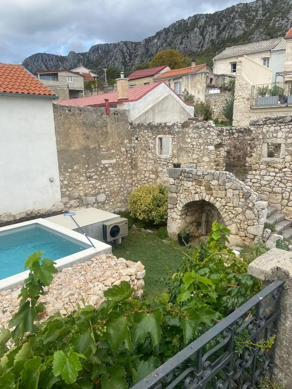 From the balcony: the pool, the ruin and the village